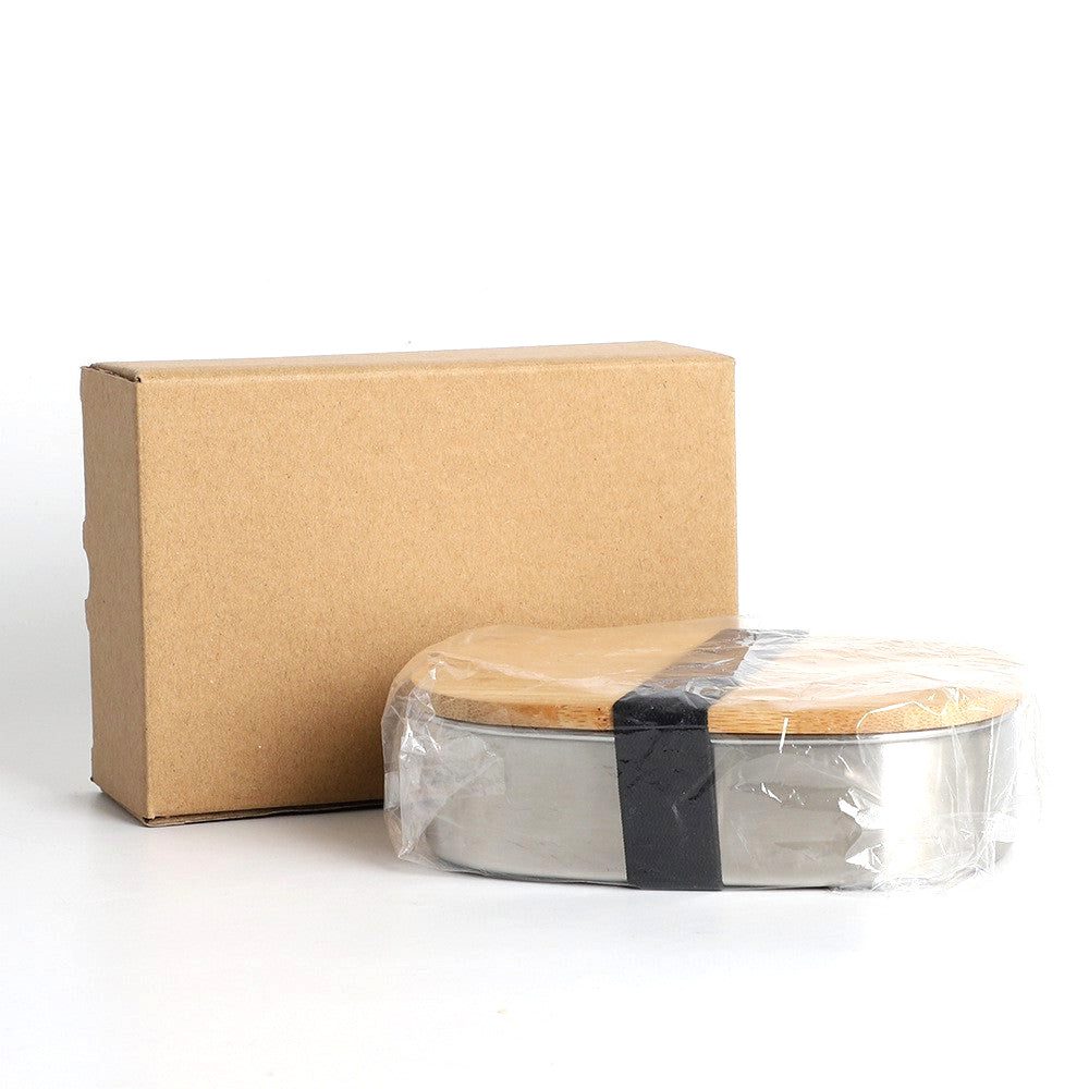 Bento en inox et bambou sous film devant son carton d'emballage