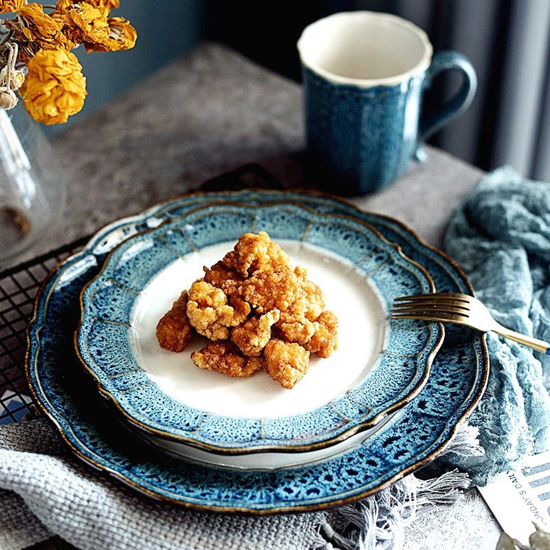 Assiette Kizoku garnie avec fourchette, tasse bleue en arrière-plan
