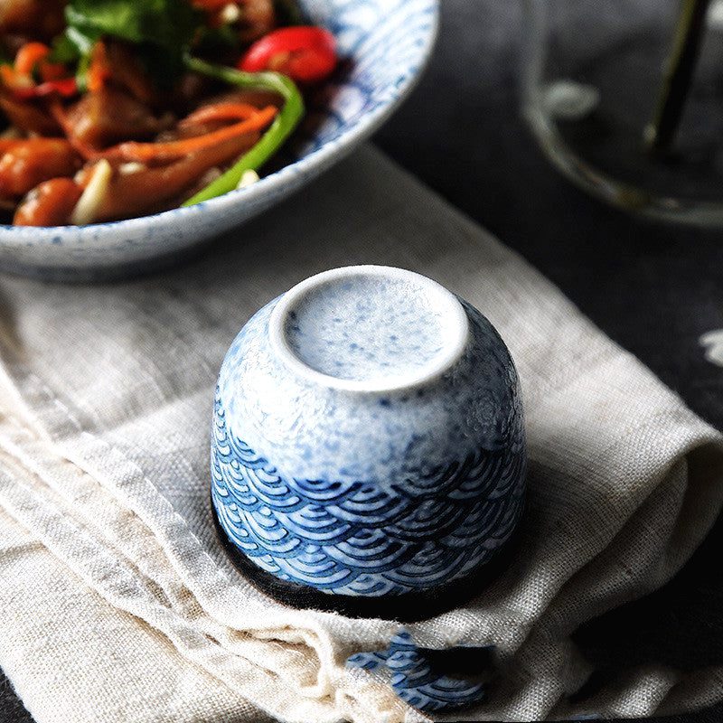 Tasse à saké Isa retournée, vue de dessous sur un linge