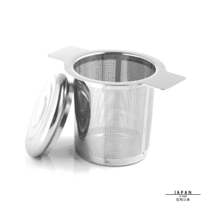 Infuseur à thé en inox avec son couvercle posé à côté, sur fond blanc